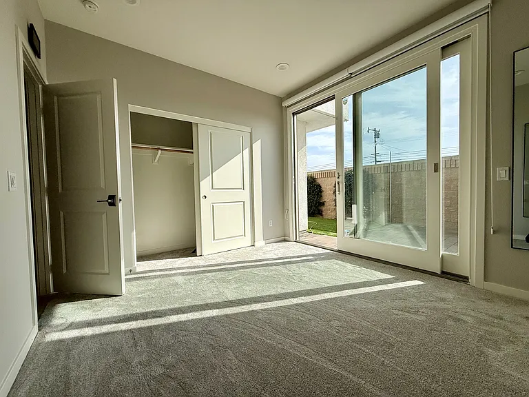 1st floor bedroom and door to backyard