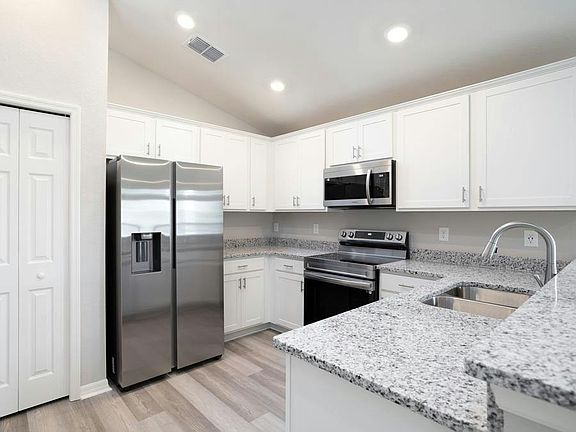 This easy-living home features a bright, open kitchen with ample cabinet and counter space, along wi