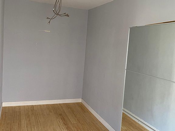 Separate sleeping area with large sliding mirrored closet.