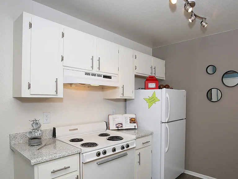 Display of Kitchen with white cabinetry and appliances