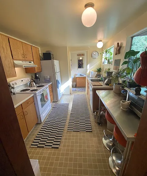Kitchen, with bathroom beyond