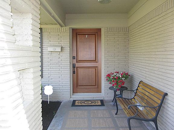 Close up of the inviting front porch and updated solid wood front door