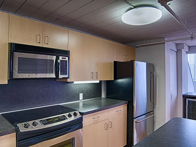 Wood flooring throughout the kitchen and living room