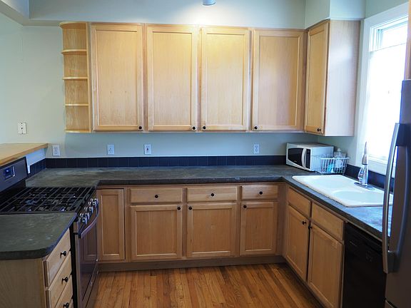 Kitchen with gas range, dishwasher, fridge, plenty of cabinet space.