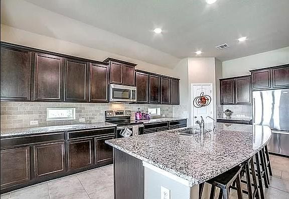 Large kitchen, walk-in pantry and sitting space at large island. All appliances are stainless; including use of existing refrigerator.