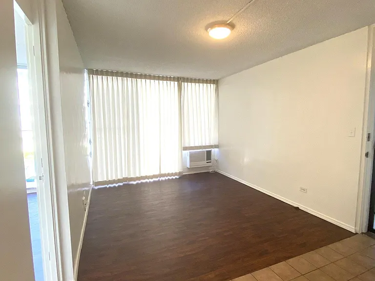 Living room w/ drapes. Freidrich window AC