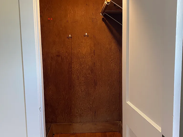 closet with stairs leading to attic