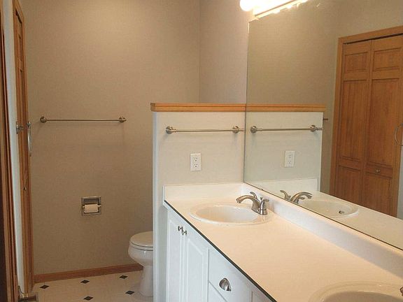 Master bath with double sinks and oval jetted tub.