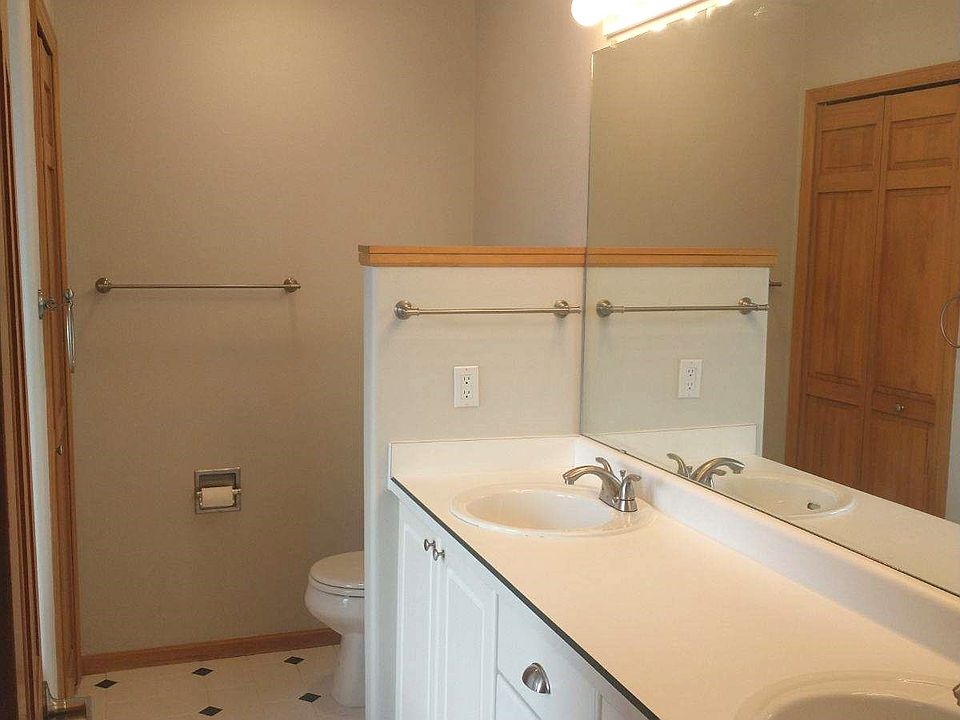 Master bath with double sinks and oval jetted tub.