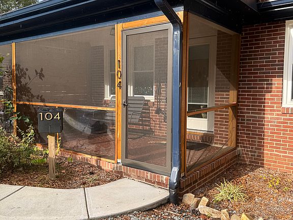 Entry with screened in front porch, parking in front of unit