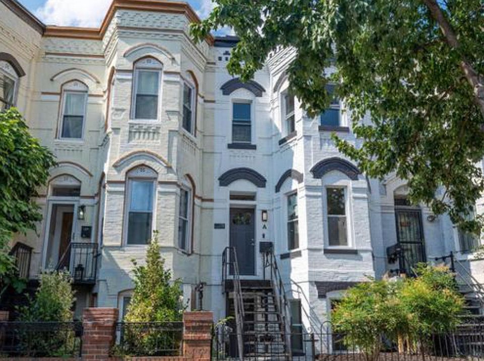 Front of brownstone with full front yard and off-street parking