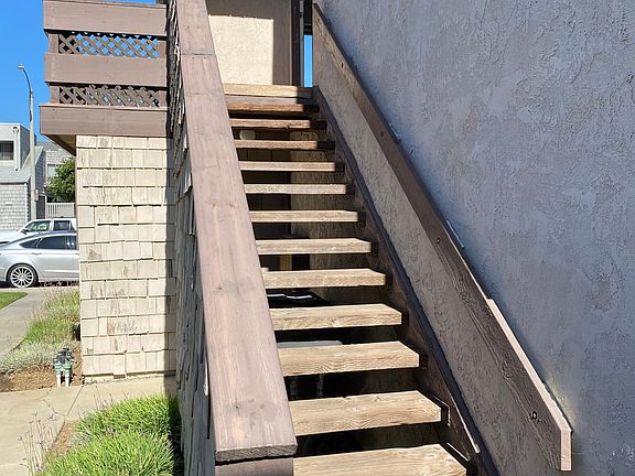 Exterior stairs leading up to front door.