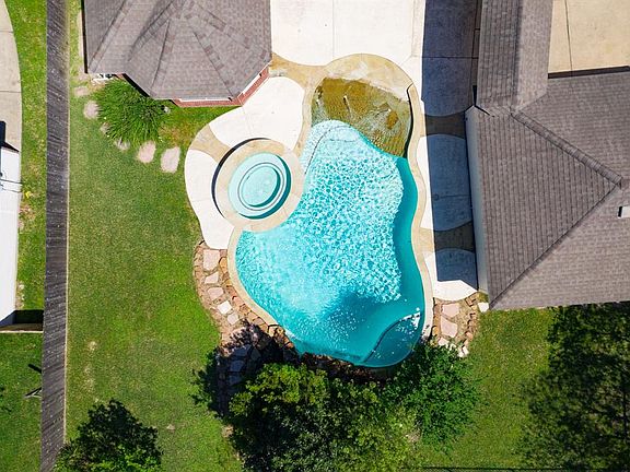 You'll spend your summers in this tranquil pool with beach entry.