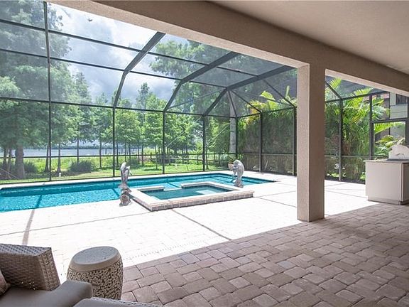 Large covered lanai with plenty of open entertaining areas and a summer kitchen with built in gas grill.