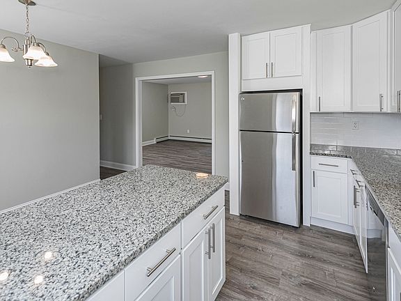 Newly renovated kitchen with white cabinets and granite countertops