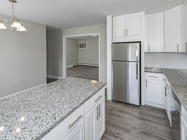 Newly renovated kitchen with white cabinets and granite countertops