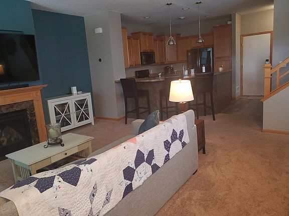 Kitchen with barstools overlooking dining and living room