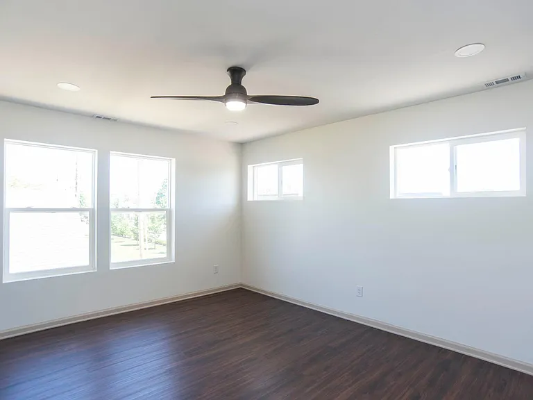 Large bedroom with windows facing yard (North)