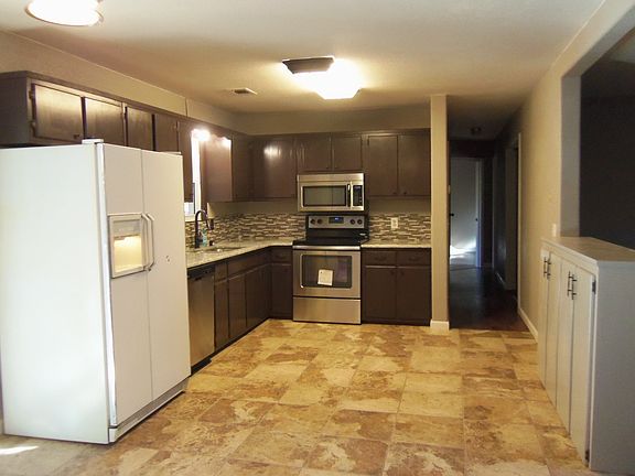 Tile kitchen with granite countertops and 1 year old stove,