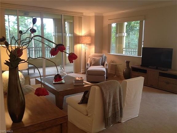 Living room opens to a wrap around screened balcony.