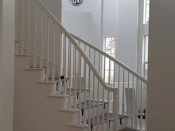 Stairs nearing completion. White riser and wooden LVT tread.