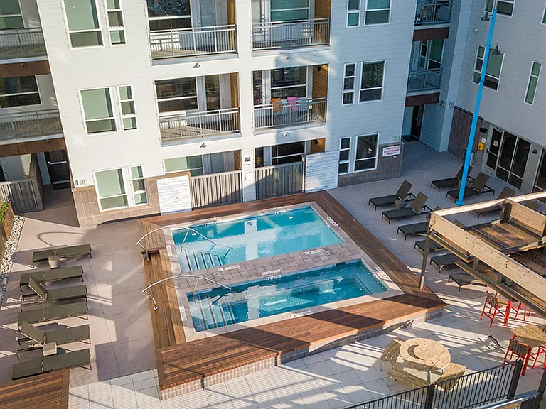 Year-round pool deck with spa, cabanas, and heated areas
