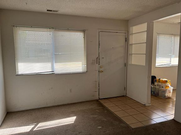 Living room with front door. The apartment will be painted and new carpet