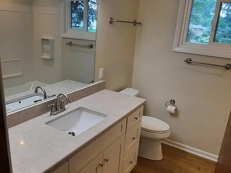All new bathroom with quartz counter top. Well light