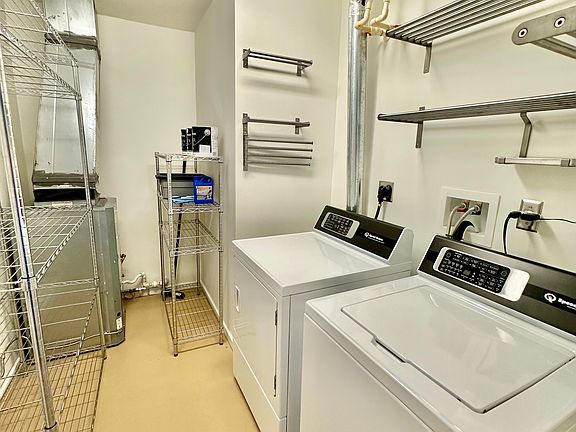 Laundry room and utility closet. Tons of durable storage options included with this unit! Brand new luxury washer & dryer by Speed Queen - the TR7 line. Full epoxy floor, fresh paint, and infrastructure upgrades throughout.