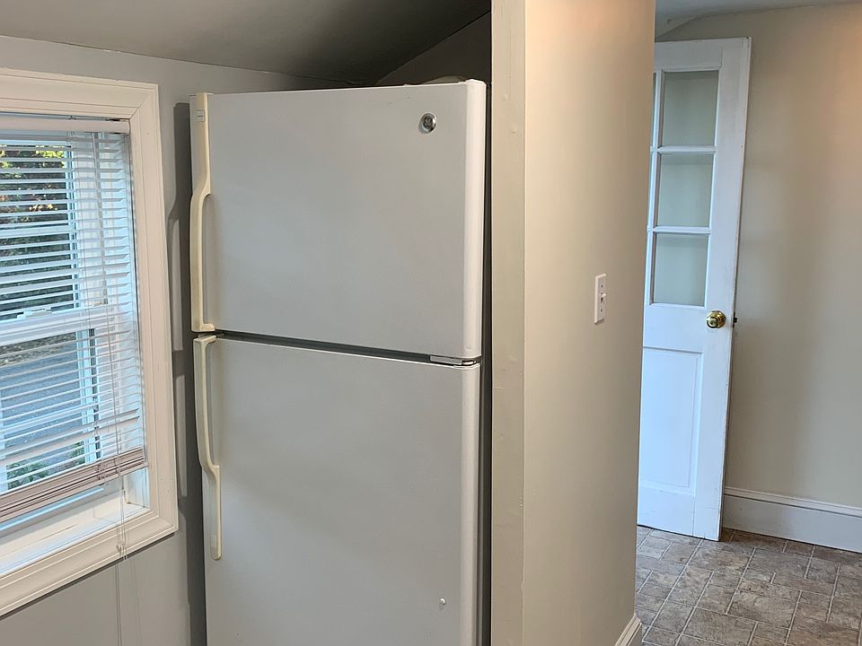 Kitchen view with front hall in background.