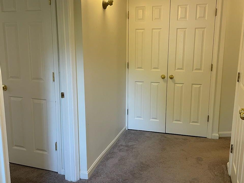 Entry hallway. To the left is the main room, and straight ahead is the laundry closet.