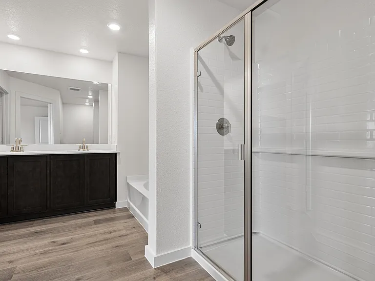 The master bathroom has a glass walk-in shower.