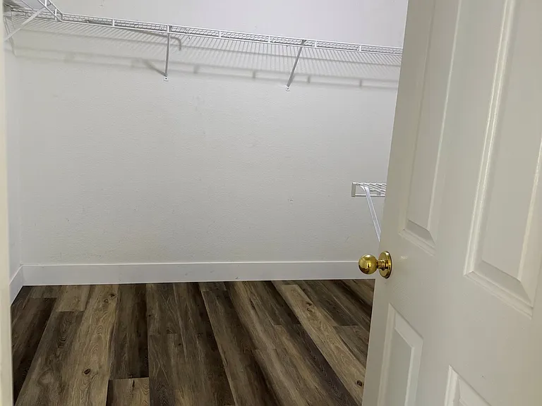 Walk in closet inside of primary suite.