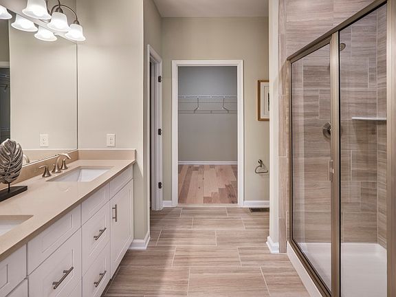 Private owner s bathroom with walk in shower and a double sink vanity