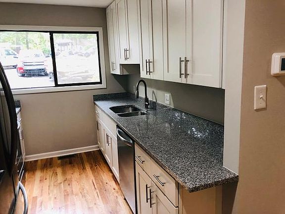 Double sink, plenty of cabinets for storage. Kitchen fully stocked.