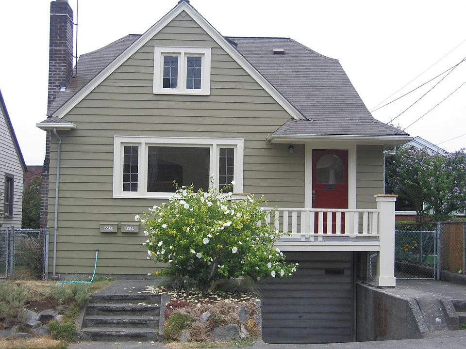 Front of house. The entry to the upstairs unit is through the gate near the chimney.