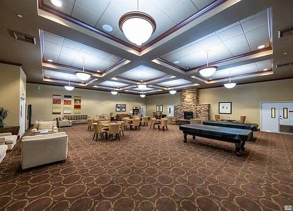 Community room with pool tables, card tables, fireplace, media room, and community kitchen. On site property manager.