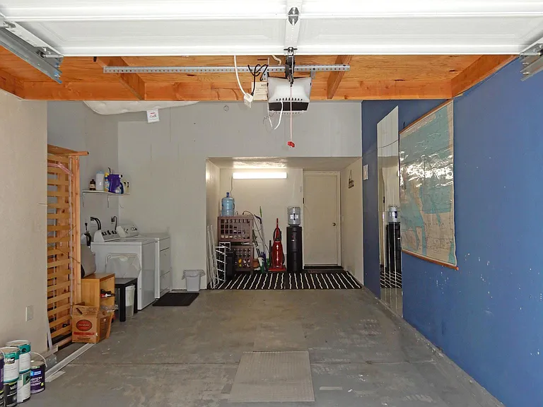 Attached 2 Car tandem garage. Full Size Washer & Dryer, Cleaning equipment and Refrigerated Water Cooler.