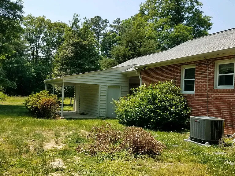 Back of house (Landlord will remove/cut shrubbery around home)