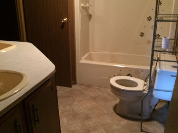 bath with two sinks lots of storage and washer dryer hookup