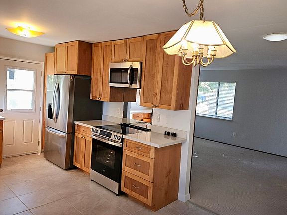 Renovated kitchen facing living room and side entrance