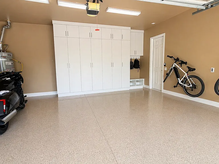 2 car garage with bike storage and EV charger. Built in floor to ceiling storage cabinets plus drop zone