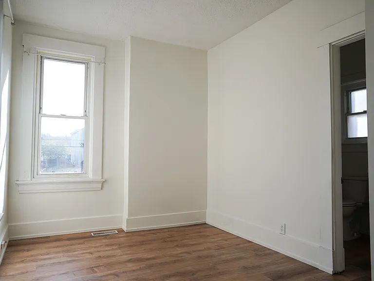 The second bedroom is perfect for an office or child's room. Brand new flooring, baseboards, paint and lighting give it a fresh, light feel.
