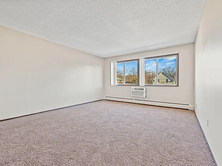 Living room with wall unit air conditioning