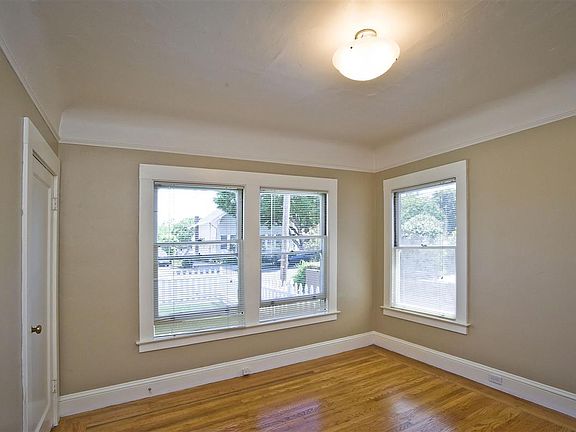 Bedroom overlooks front yard. Bright and airy. Walk-in closet. Original 1917 hardwood floors through-out.
