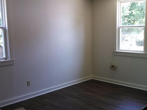 Dining room off kitchen with new flooring and windows.