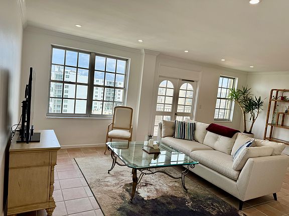 Living area with recessed lighting, freshly painted white walls