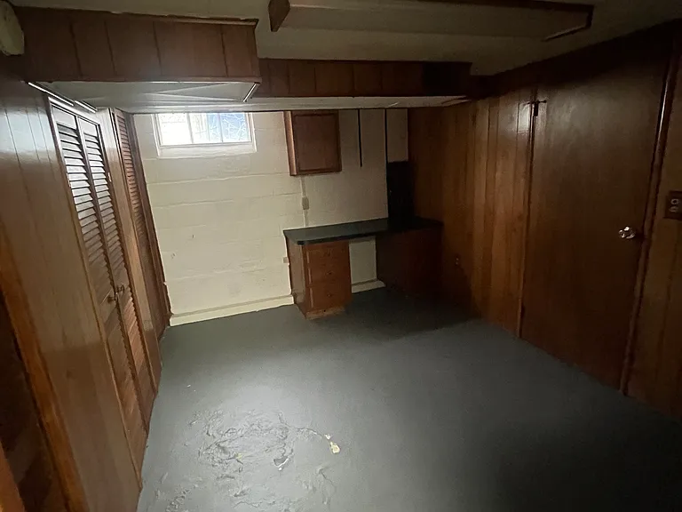 storage room off of laundry room with built ins