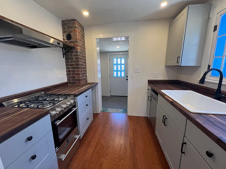 Standing in kitchen, looking towards mudroom and backyard.