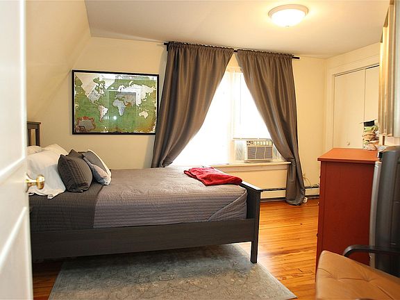 Bedroom with top floor view of Forest St - Montclair Bread Company. King size bed in photo.